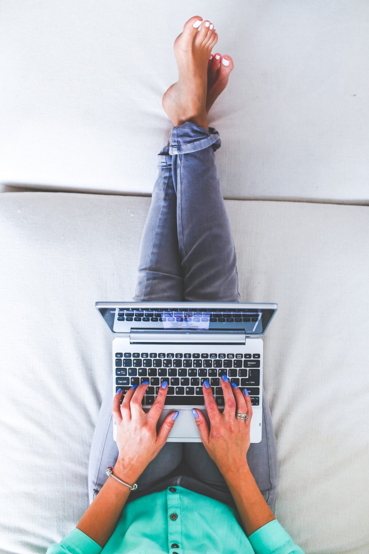 woman working from home on bed